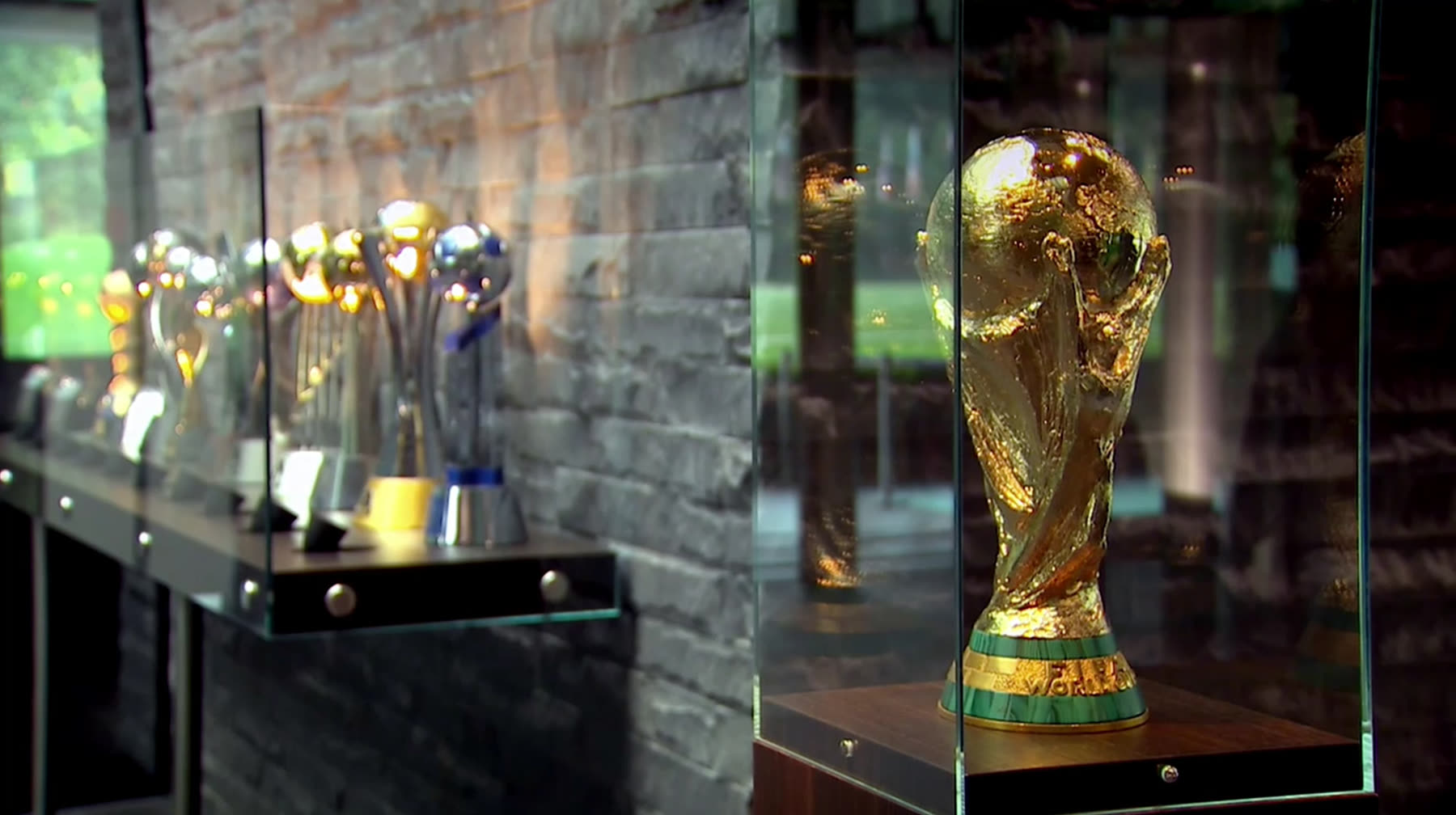 The FIFA World Cup trophy in a glass display case